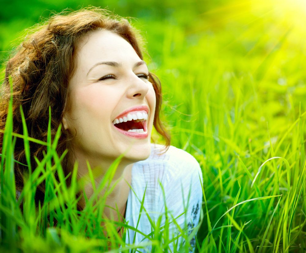 Laughing woman in the grass