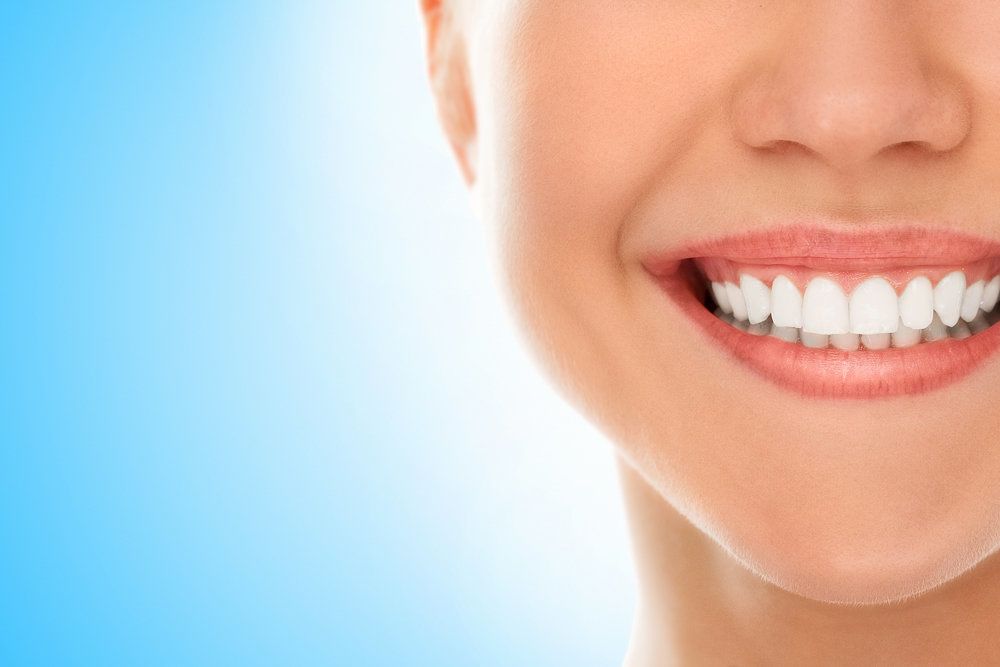 Woman with healthy teeth and gums smiling